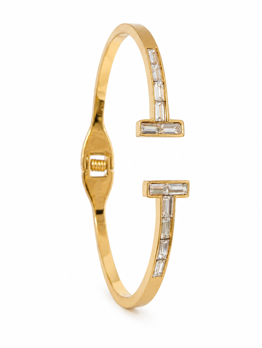 Gold bracelet with diamond accents on a white background