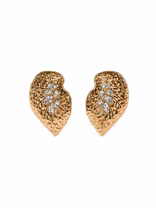 Gold leaf-shaped earrings with diamond accents on a white background
