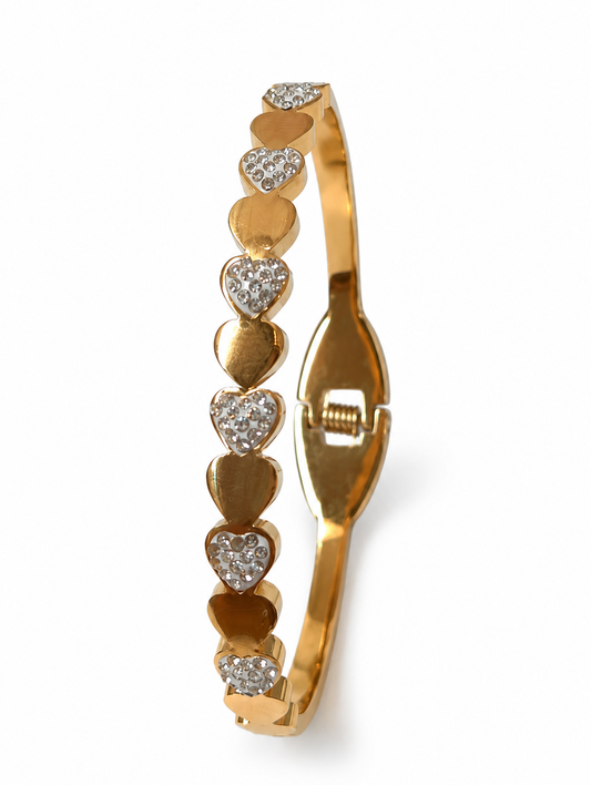 Gold bracelet with heart-shaped charms on a white background