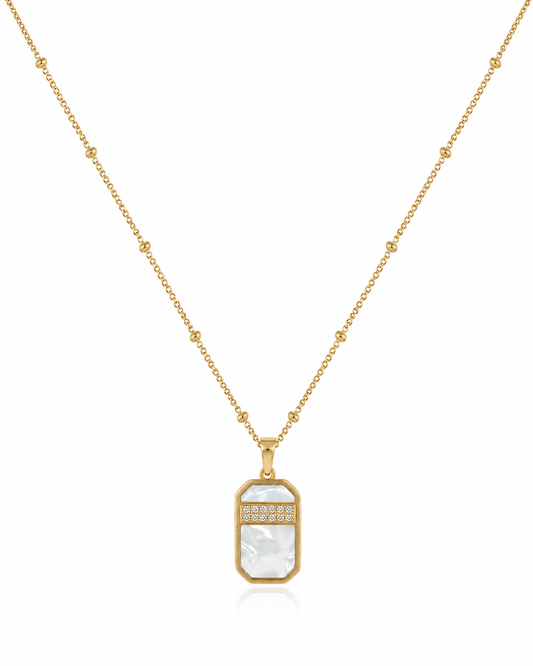 Gold necklace with a rectangular pendant on a white background